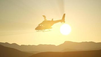 Helicóptero volador en cámara lenta extrema y cielo al atardecer foto