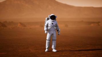 Astronaut on Mars Surface. Red Planet Covered in Gas and rock photo