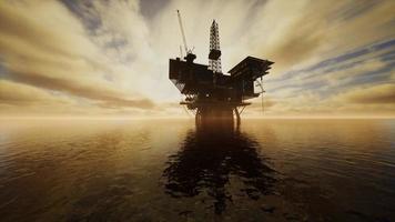 Offshore Jack Up Rig in The Middle of The Sea at Sunset Time photo