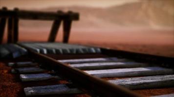 Abandoned railway tracks in the desert photo