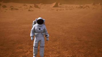 Astronaut on Mars Surface. Red Planet Covered in Gas and rock photo