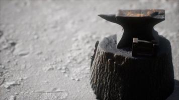 Old anvil attached to a stump photo