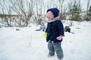 Baby girl in winter nature. Outdoors in snow. photo