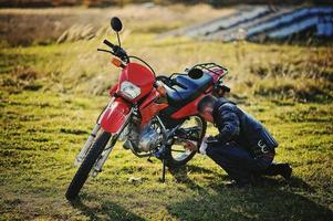 Cyclist repairing a bike at grass photo