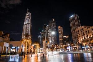 Beautiful view to Dubai downtown city center skyline from Design District at night, United Arab Emirates. Timelapse video. photo