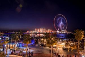 Beautiful Dubai eye or Ain Dubai on the Jumeirah beach at night. Beautiful lights of the ferris wheel in Dubai photo