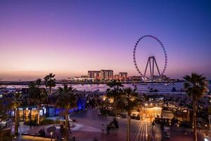 Beautiful Dubai eye or Ain Dubai on the Jumeirah beach at sunset. Magical sunset time in Dubai by the Ferris wheel. photo