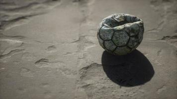 Old soccer ball the cement floor photo