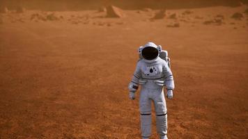 Astronaut on Mars Surface. Red Planet Covered in Gas and rock photo