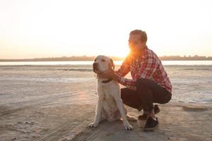 Young male having good time on mornink walk with dog photo