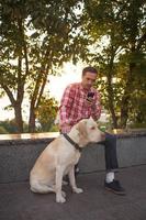 Morning walk of young male and gold labrador dog photo