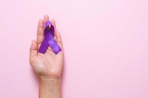 Hands holding Purple ribbons world cancer day concept photo