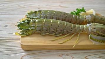 fresh mantis shrimp with lemon on wood board video