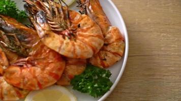 grilled tiger prawns or shrimps with lemon on wood board video