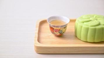 Chinese moon cake green tea flavour with tea on wood plate video