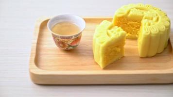 Chinese moon cake custard flavour with tea on wood plate video