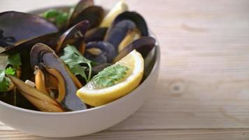 fresh mussels with herbs in a bowl with lemon video