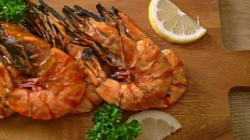 grilled tiger prawns or shrimps with lemon on wood board video