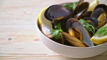 fresh mussels with herbs in a bowl with lemon video