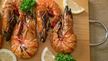 grilled tiger prawns or shrimps with lemon on wood board video