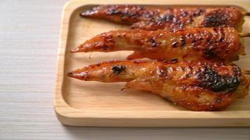 grilled or barbecue chicken wings skewer with sticky rice video