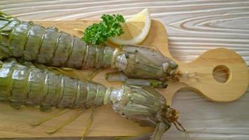 fresh mantis shrimp with lemon on wood board video