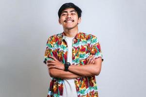 man wearing casual shirt over white background happy face smiling with crossed arms looking at the camera. positive person. photo