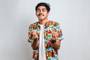 Man wearing casual shirt doing money gesture with hands, asking for salary payment, millionaire business photo