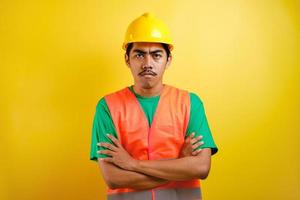 Young handsome asian indian worker man looked angry with crossed arm photo