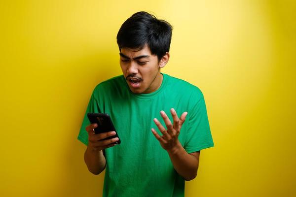 Sad Asian Man Has Bad Online Chat News And Feels Disappointed On The  Smartphone. Stock Photo, Picture and Royalty Free Image. Image 175416709.