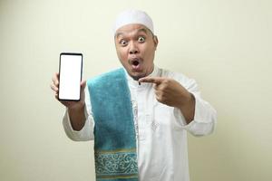 Fat Asian Muslim men looks surprised at the good news on phone photo