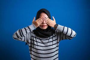 Asian muslim woman Wearing Hijab Covering her eyes photo