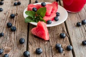 Fresh sliced watermelon on a wooden background photo