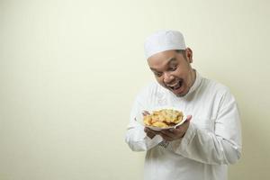 Fat Asian Moslem men feel very hungry and want to immediately devour food photo