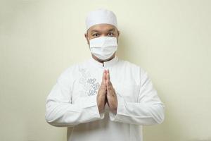 Asian Muslim men wearing mask with various gesture and expression photo