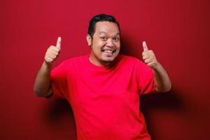 Portrait of happy asian man showing thumbs up photo