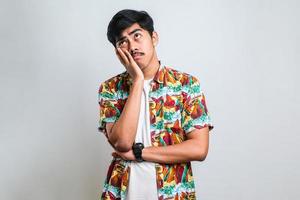 Man wearing casual shirt thinking looking tired and bored with depression problems with crossed arms. photo