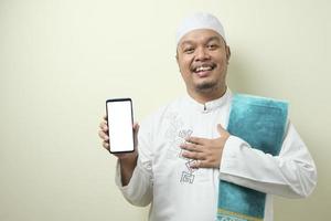 Fat Asian Muslim men looks surprised at the good news on phone photo