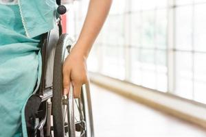 Young disabled woman sitting in the wheelchair photo