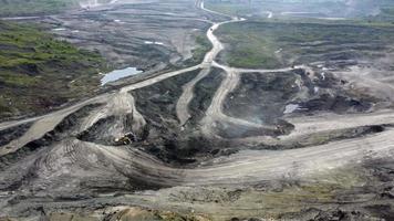 Aerial view of open mine pit. Drone shot of coal mining activity. Water Pollution. Extraction. Destroyed landscape. Apocalyptic environment. Disruption of nature. video