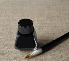 Ink bottle with brush for painting painting photo