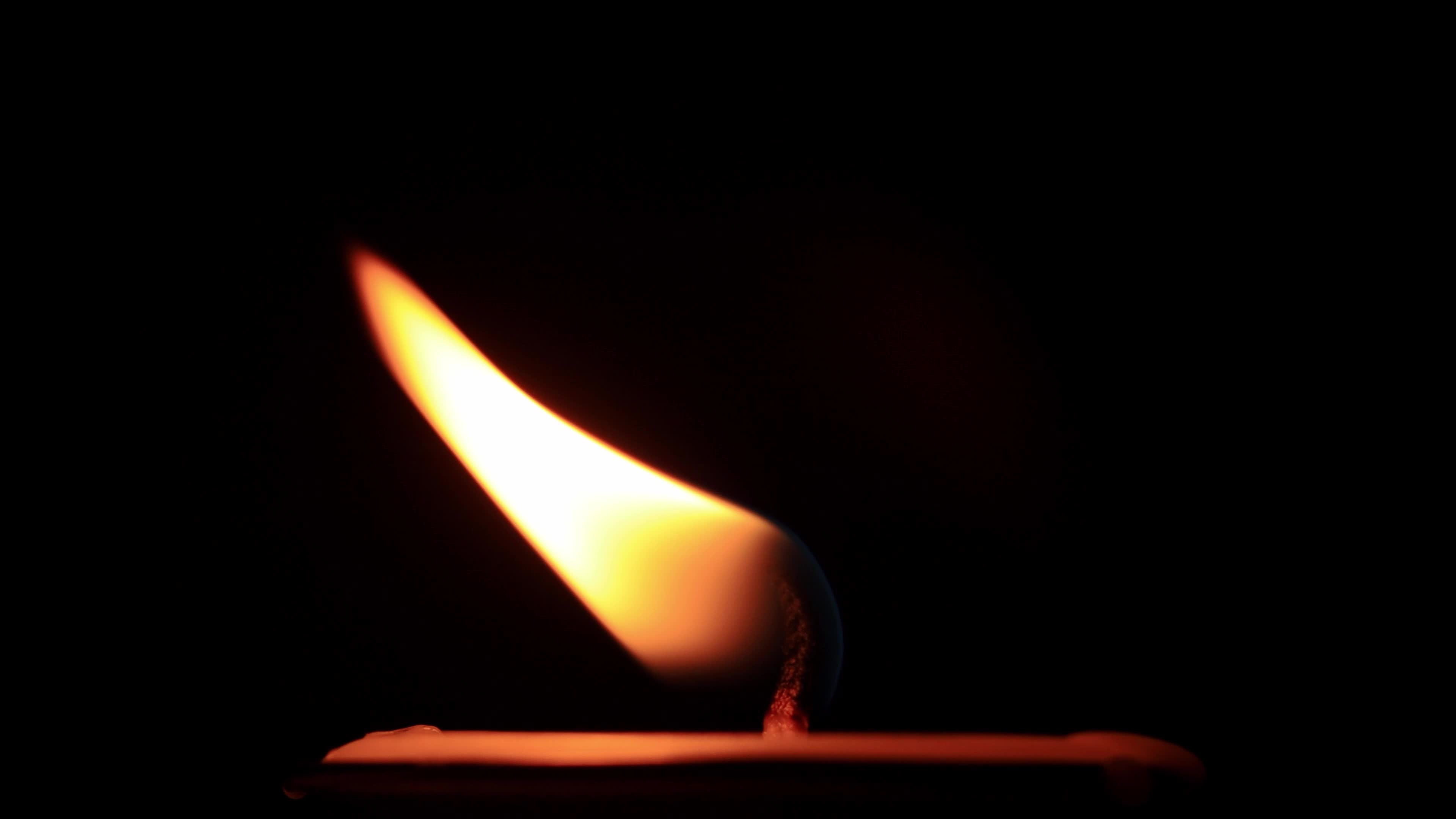 Candle flame on black background 5879437 Stock Video at Vecteezy