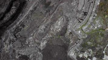 veduta aerea di lavoro miniera a cielo aperto. colpo di drone dell'attività di estrazione del carbone. estrazione. macchine funzionanti. paesaggio distrutto. ambiente oscuro e apocalittico. sconvolgimento della natura. polvere e inquinamento. video