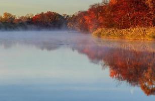 Autumn foggy morning. Dawn the misty tranquil river photo