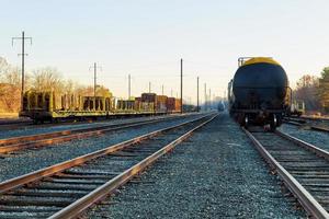 Railroad in autumn going to the city with colorful trees in colors by the tracks in the fall photo