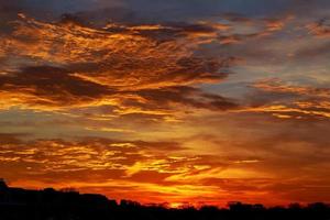 Red, cloudy sky at sunset photo