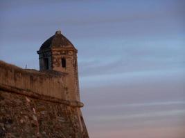 Tower of the defensive wall of a medieval bastion photo