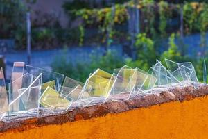 Dangerous wall with broken glass shards Playa del Carmen Mexico. photo