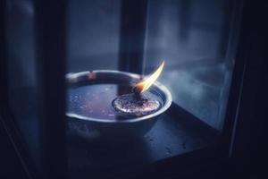 Burning candle tea lights in Thai temple. photo