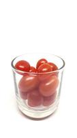 cherry tomatoes in glass Isolated on white background photo